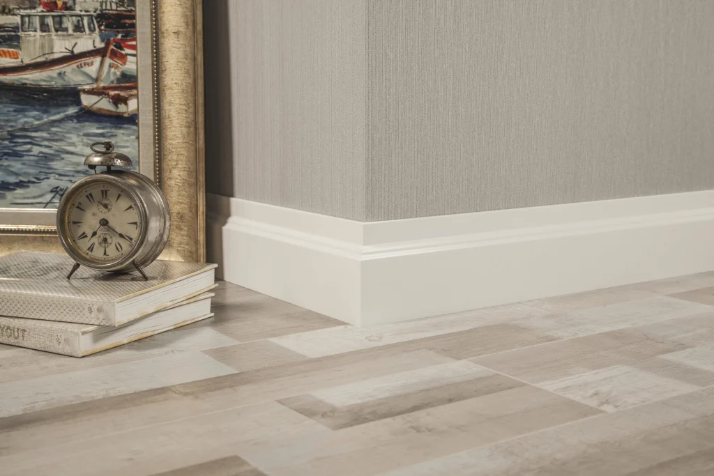 White foil-wrapped MDF skirting along a light wall